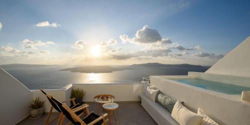a balcony with a view of the ocean at Panorama Suites in Fira