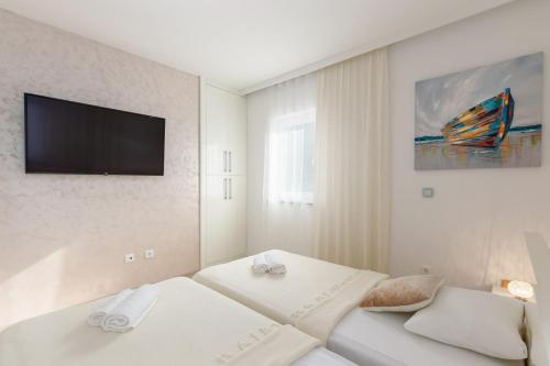 Giường trong phòng chung tại Tarari Luxury Apartment