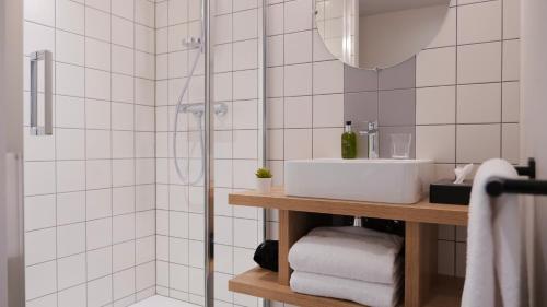 a bathroom with a sink and a shower at Plan B Hotel - Living Chamonix in Chamonix-Mont-Blanc