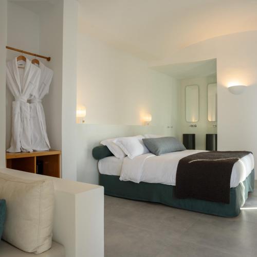 a bedroom with a large bed in a room at Panorama Suites in Fira