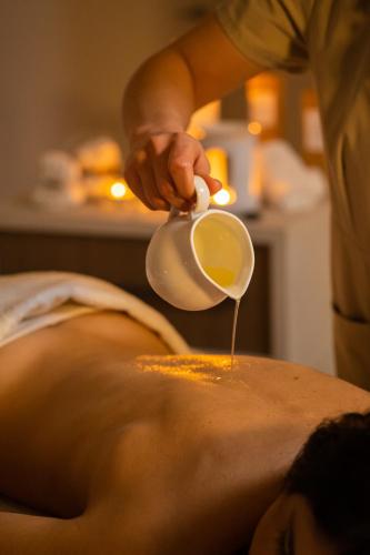 a man is getting a massage at Torre Cintola Greenblu Sea Emotions in Monopoli