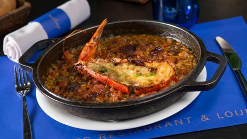 a pan of food with a lobster on a plate at Carlemany Girona in Girona