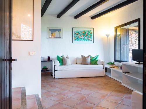 ein Wohnzimmer mit einem weißen Sofa und einem TV in der Unterkunft Casa 93 - Klodge in Porto Rotondo