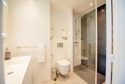 a bathroom with a toilet and a sink and a shower at High Standing with Incredible Old Antibes and Sea views in Antibes