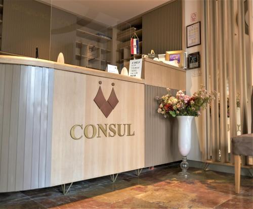 a restaurant with a counter with a crown sign on it at Hotel Consul in Split