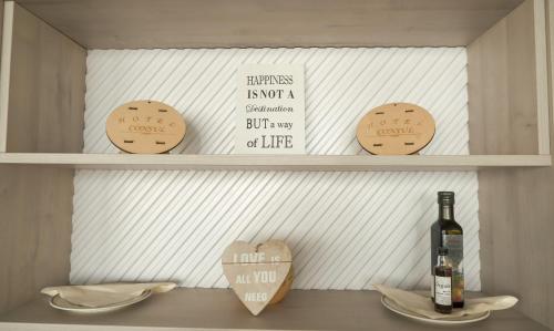 a shelf with cookies and a bottle of wine at Hotel Consul in Split