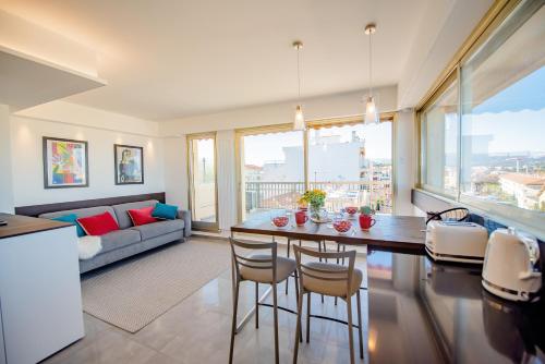 a kitchen and living room with a table and chairs at High Standing with Incredible Old Antibes and Sea views in Antibes