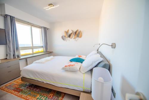 a bedroom with a bed with a lamp on it at High Standing with Incredible Old Antibes and Sea views in Antibes