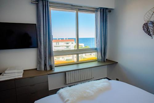 a bedroom with a window with a view of the ocean at High Standing with Incredible Old Antibes and Sea views in Antibes