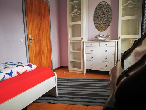 a bedroom with a bed and a dresser and a mirror at HR Townhouse Honigbach in Coesfeld