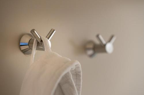 a towel hanging on a towel rack in a bathroom at Hotel Au Quartier in Maastricht