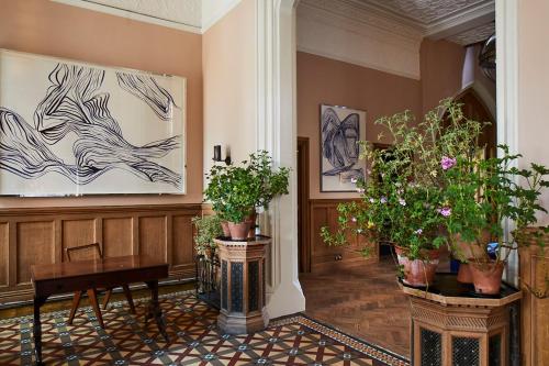 a hallway with potted plants on the walls at Oakley Court in Windsor