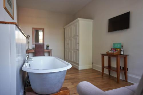 a bathroom with a large bath tub in a room at Hotel Du Vin & Bistro Tunbridge Wells in Royal Tunbridge Wells
