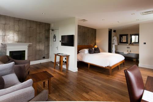 a bedroom with a bed and a living room at Hotel Du Vin & Bistro Tunbridge Wells in Royal Tunbridge Wells