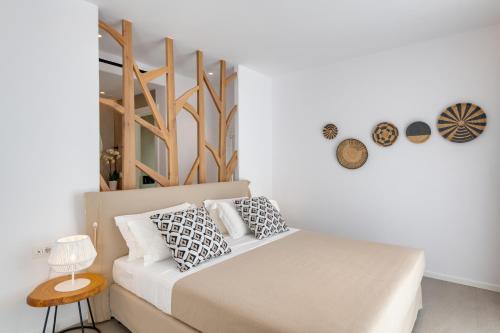 a bedroom with a bed with pillows on it at Elia Mykonos Resort in Elia Beach