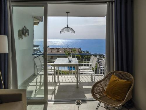 a room with a balcony with a table and chairs at Sitges Spaces Sea View Paradise 5 min from Balmins in Sitges