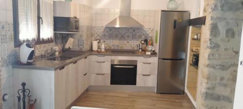 eine Küche mit einem Kühlschrank aus Edelstahl und einer Spüle in der Unterkunft VTAR Casa del AOVE in Baeza