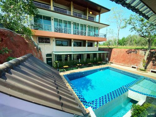 an image of a swimming pool in front of a building at Keree Lakeview in Chanthaburi