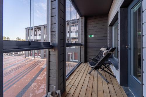 a balcony with a bench and a large window at Hilmantori Apartments by Hiekka Booking in Kalajoki