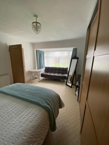 a bedroom with a bed and a couch at 14 Easby Lane in Great Ayton