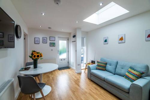 a living room with a blue couch and a table at Lady Bay Apartments in Nottingham