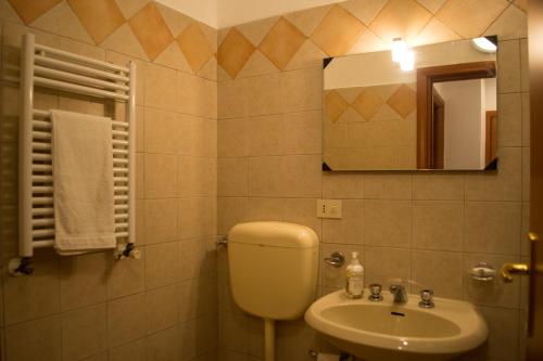 un bagno con un water, un lavandino e uno specchio di Casa Mare Naxos Flat - Home Holiday a Giardini Naxos