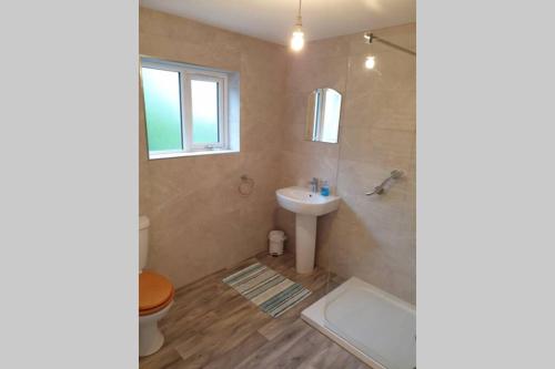 a bathroom with a sink and a toilet and a tub at 2 bed house at Ballycastle seafront in Ballycastle