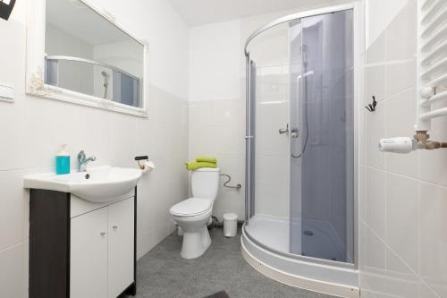 a bathroom with a toilet and a sink and a shower at Krab in Rewal