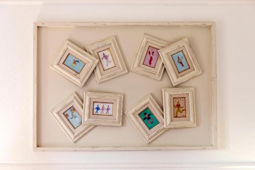 a group of framed pictures on a wall at Grand Hotel De Rose in Scalea