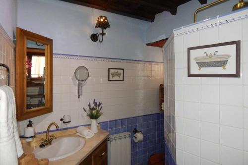 a blue and white bathroom with a sink and a tub at La Casona Del Almendro in San Bartolomé de Tirajana