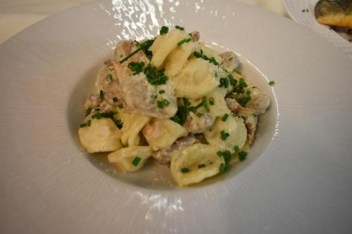 a white plate of pasta with parsley on it at Le Cheval Blanc - Lac du Der - Logis Hotel in Giffaumont