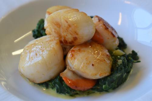 a white plate of food with potatoes and vegetables at Le Cheval Blanc - Lac du Der - Logis Hotel in Giffaumont
