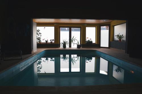 a house with a swimming pool in the middle at Penzion U Šelongů in Jindrichuv Hradec