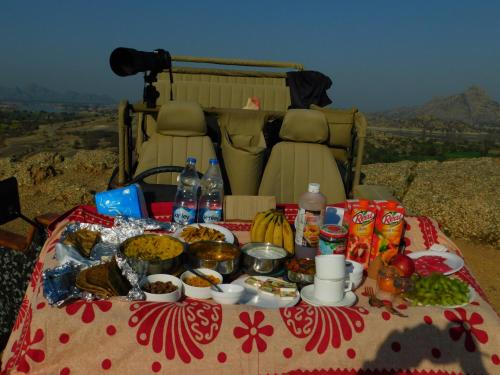 a table with food and drinks on top of a vehicle at Jawai Bera Leopard Camp in Bera