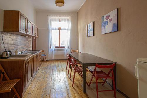 eine Küche mit einem Tisch und Stühlen im Zimmer in der Unterkunft For celebrations spacious 3BDR apartment with balcony in Prag