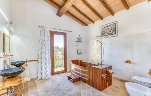 a bathroom with a sink and a toilet and a window at Casale Di Vulci in Case Riminino
