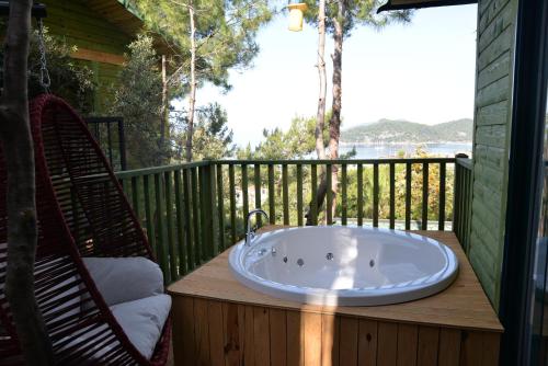 a bath tub sitting on a deck with two chairs at Symbola Oludeniz Beach Hotel in Oludeniz