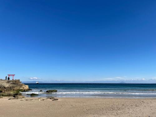 a sandy beach with the ocean in the background at Guesthouse All you need - All rooms have an ocean view! in Shimoda