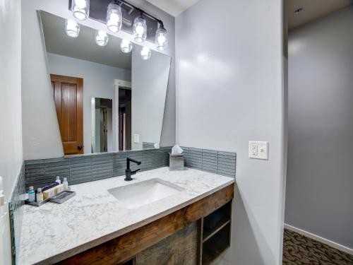 a bathroom with a sink and a mirror at The Gonzo Inn in Moab