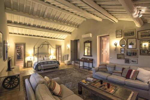 a large living room with a bed and a couch at Commenda Cavalieri Ordine di Malta in Vignanello