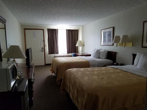 a hotel room with two beds and a television at Quality Inn New River Gorge in Fayetteville