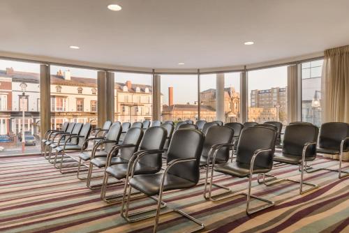 a row of chairs in a room with windows at Waterfront Southport Hotel in Southport