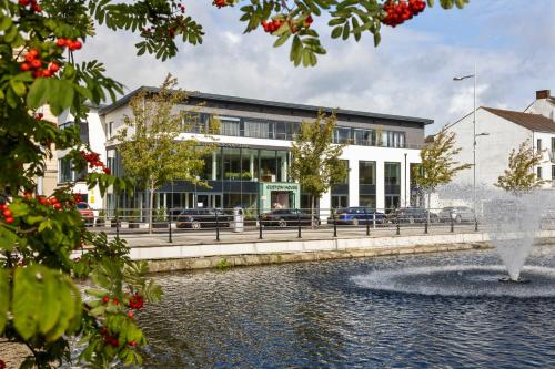a building with a fountain in front of a building at Custom House Apartments in Newry