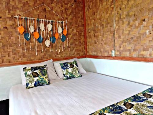 a bed in a room with two pillows at Paddies Homestay New in Cipaku-gede