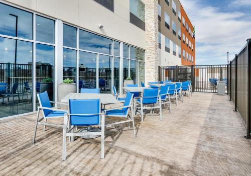 a cafeteria with blue chairs and tables on a building at Holiday Inn Express - Kermit by IHG in Kermit