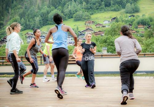 a group of people walking on a bridge at Résidence Club MMV La Clé des Cimes in Arêches