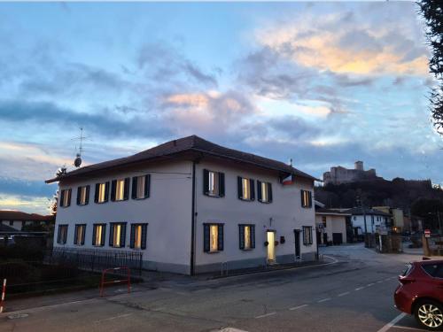 a white building with lights on in a parking lot at Dragonfly Appartamento Blu in Angera