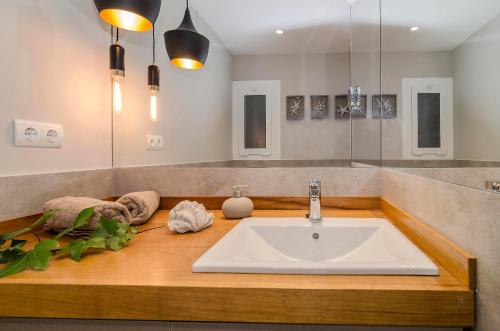 a bathroom with a sink and a mirror at Sitges Spaces Deluxe Centre Apartment in Sitges