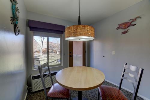 a table and chairs in a room with a window at The Gonzo Inn in Moab