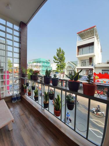 a balcony with a bunch of potted plants at Homestay Khoa Chaudoc in Chau Doc